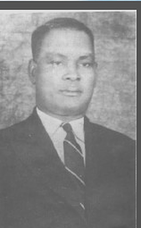 Black-and-white archival portrait of Chief Mukoro Mowoe (1890–1948) in his characteristic dark European suit